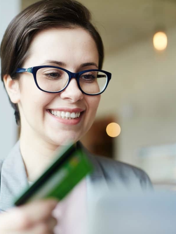 Modern woman with plastic card shopping in web